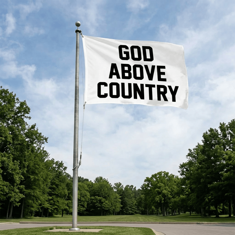 White flag with text 'GOD ABOVE COUNTRY' above American flag on pole in front of church