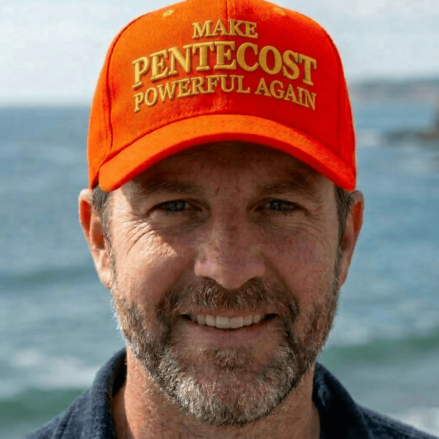 Man smiling wearing a red hat with 'Make Pentecost Powerful Again' text
